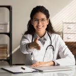 nurse with outstretched hand representing the financial benefits of outsourcing healthcare recruiting