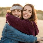 two smiling women who are making friends as travel nurses